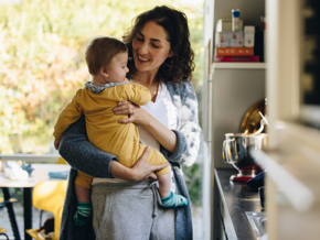 Mother holding baby in arms in a kitchen