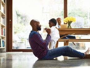 father and daughter playing with mother in the background