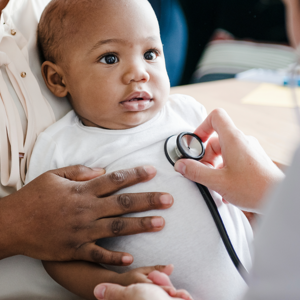 Baby with doctor having heart listened to