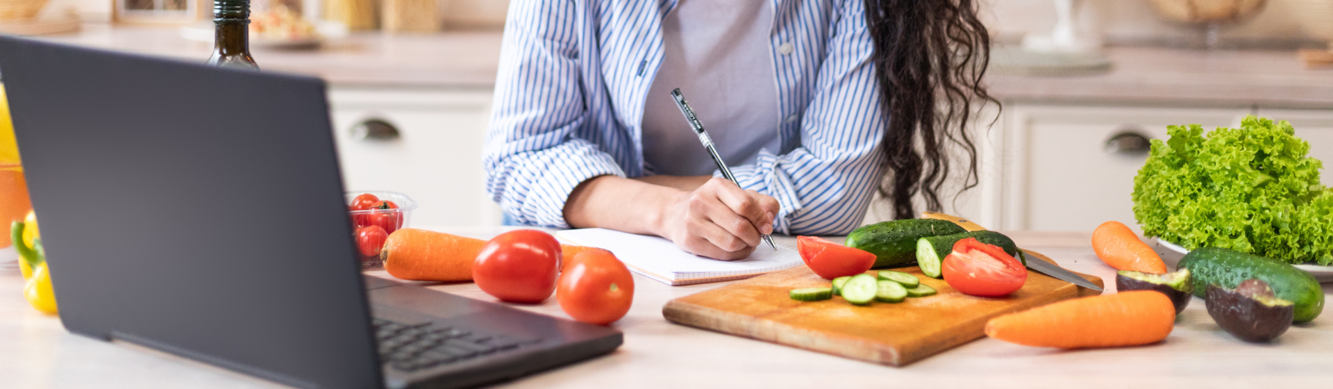 writing down a menu in the kitchen with food around